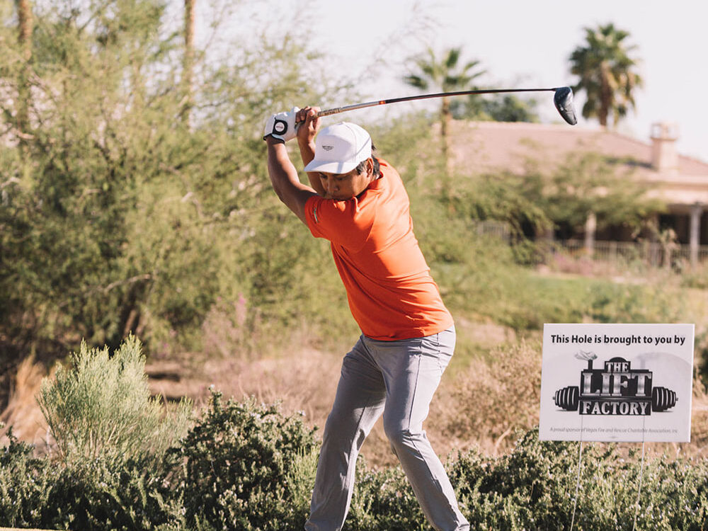 Man swinging with The Lift Factory Hole Sponsor behind him