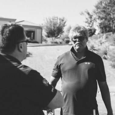 Two guys chatting in black and white