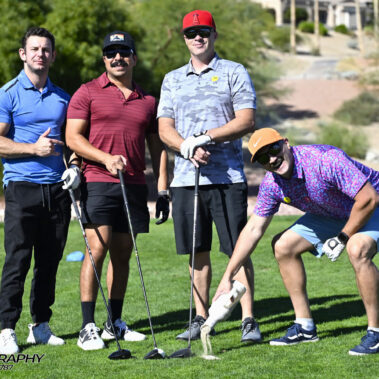 4 golfers posing for a photo on the golf course.
