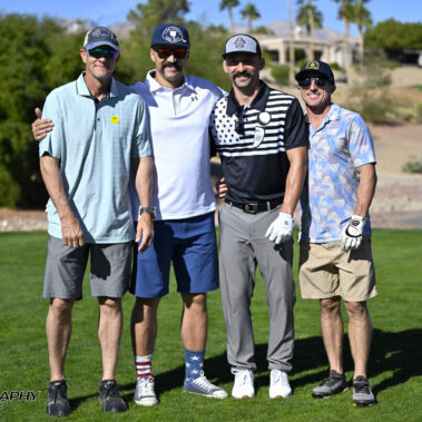 4 golfers posing for a photo on the golf course.