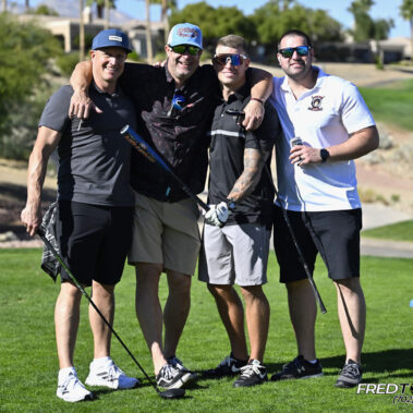 4 golfers posing for a photo on the golf course.