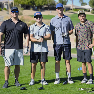 4 golfers posing for a photo on the golf course.
