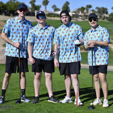 4 golfers posing for a photo on the golf course.