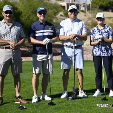 4 golfers posing for a photo on the golf course.