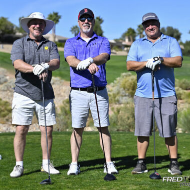 4 golfers posing for a photo on the golf course.