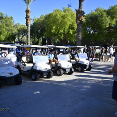 Jeff Halverson talking to golfer in their golf carts.