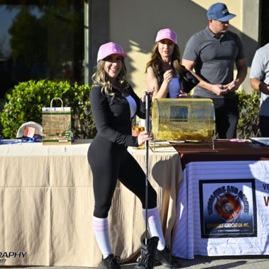 Lady posing at raffle table.