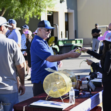 Golfers purchasing raffle tickets.